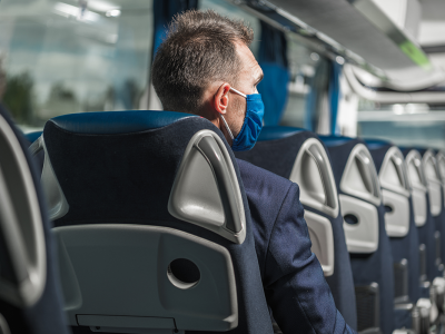 male-passenger-with-face-mask-sitting-inside-of-bu